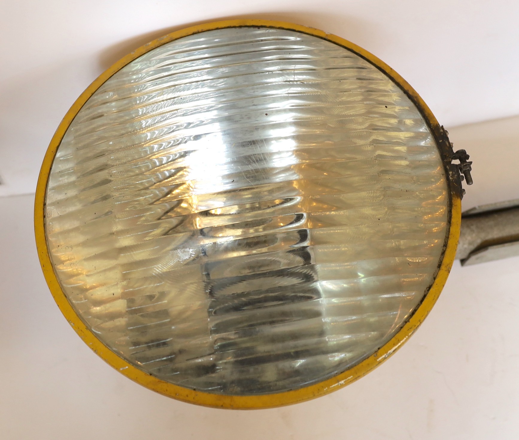 A 1950s yellow enamelled and aluminium floodlight, height 70cm. diameter 34cm